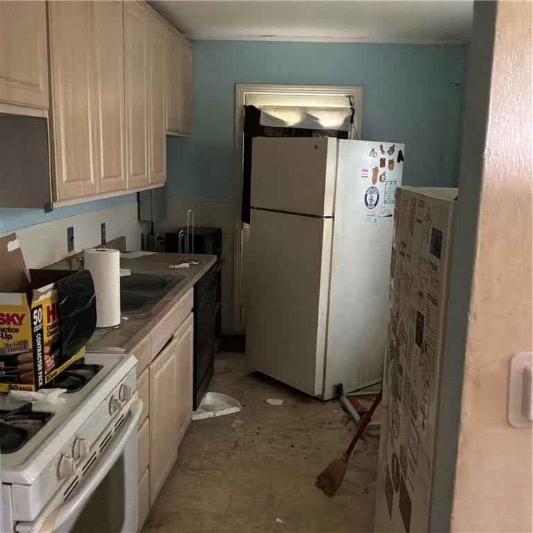 Gas range, wood kitchen cabinets and white appliances at 2743 31 Street N, Kansas City, KS 66104