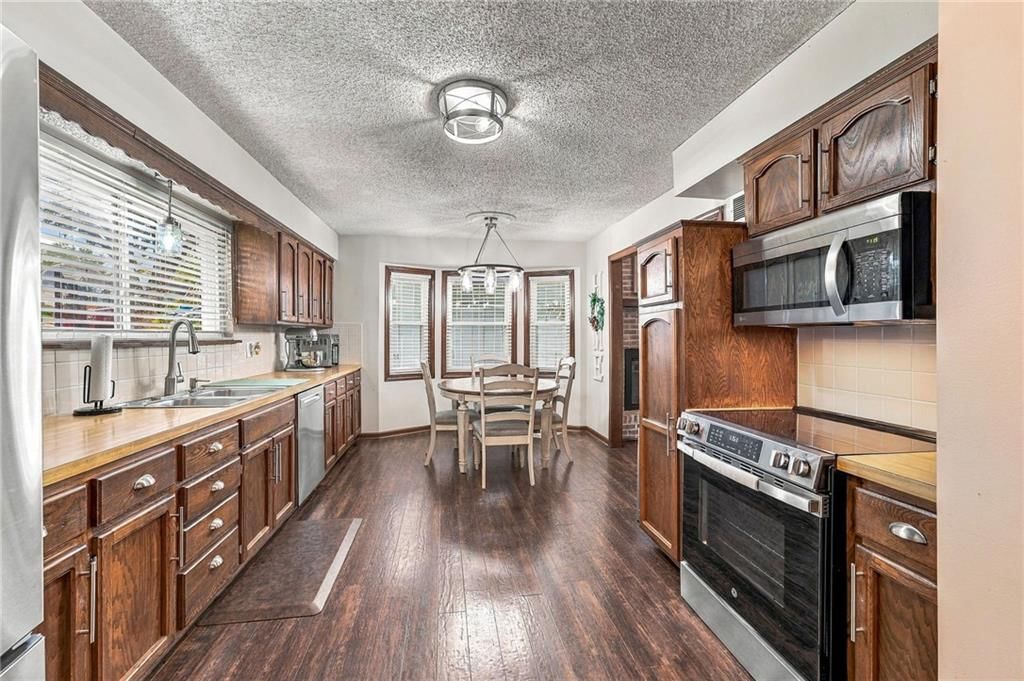 Hardwood floors, stainless steel appliances and wood kitchen cabinets at 14315 W 65th Street, Shawnee, KS 66216