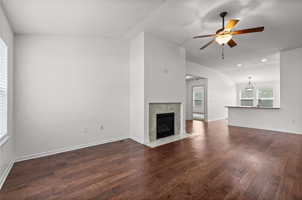 Fireplace, open floor plan and hardwood floors at 3305 NW 87th Street, Kansas City, MO 64154
