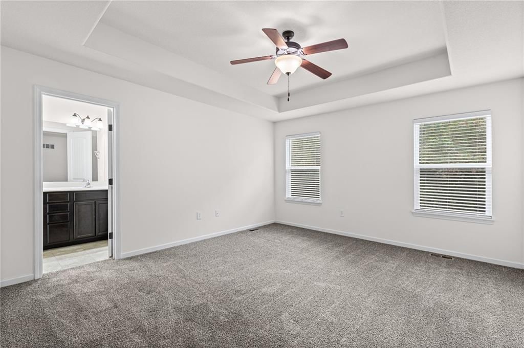 Main-floor primary bedroom and tray ceiling at 3305 NW 87th Street, Kansas City, MO 64154