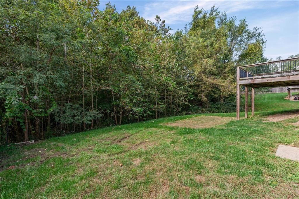 Mature trees and flat lot at 3305 NW 87th Street, Kansas City, MO 64154