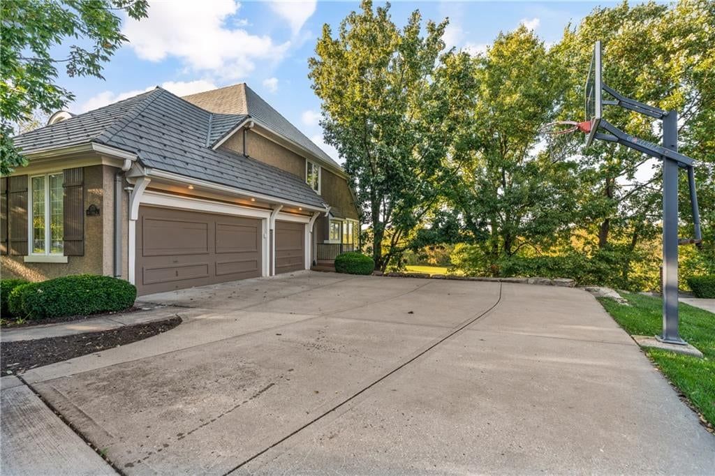 Garage for three or more cars, attached garage and concrete driveway at 3608 W 153rd Street, Leawood, KS 66224
