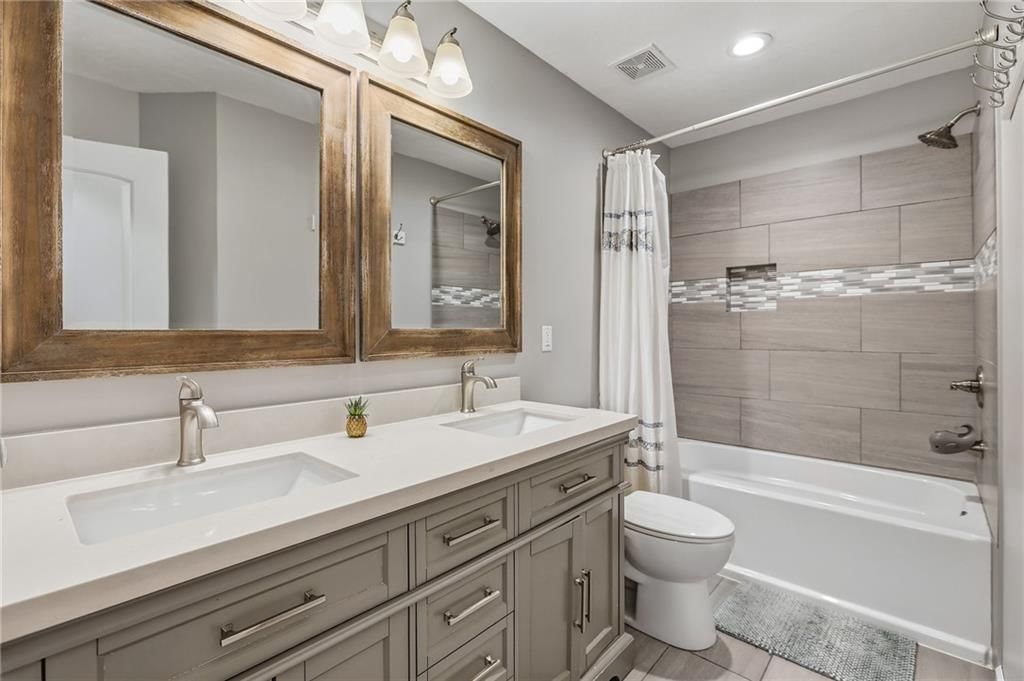 Tiled shower, double vanity and renovated bathrooms at 14513 90TH Court, Lenexa, KS 66215