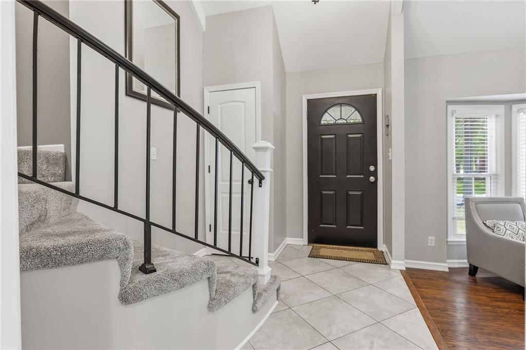 Tile floors, staircase and iron stair railing at 14513 90TH Court, Lenexa, KS 66215