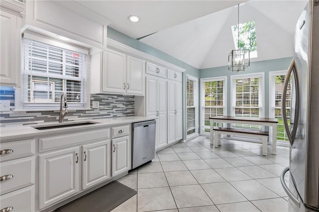 White kitchen, wall of windows and stainless steel appliances at 14513 90TH Court, Lenexa, KS 66215