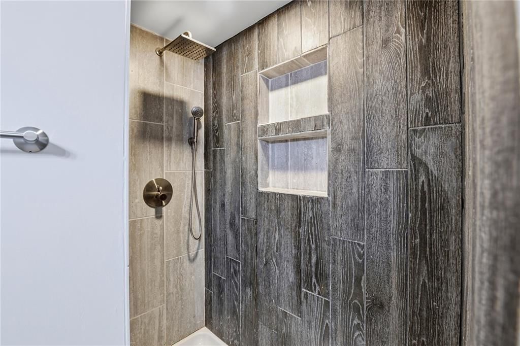 Walk-in shower and tiled shower at 4922 Blue Lane, Kansas City, KS 66104