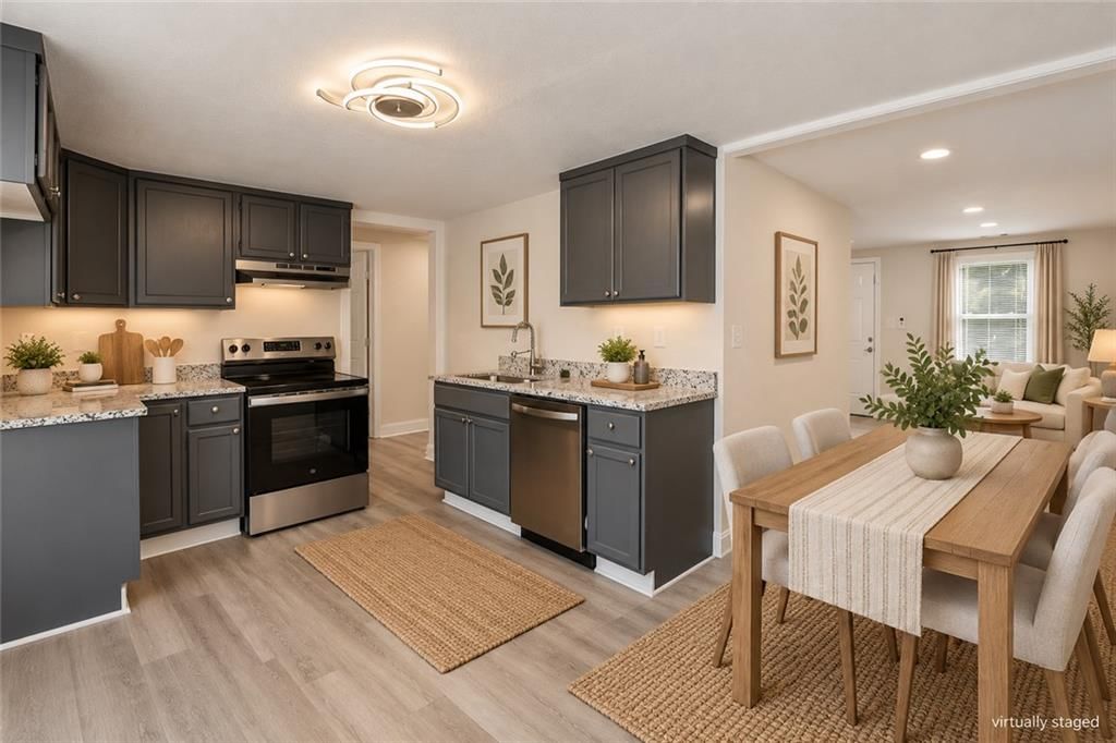 Open floor plan, granite counters and gray kitchen cabinets at 4922 Blue Lane, Kansas City, KS 66104