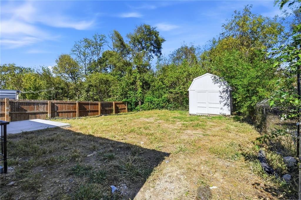 Fenced yard, concrete patio and flat lot at 4922 Blue Lane, Kansas City, KS 66104
