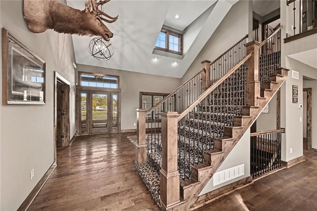 Tall ceilings, hardwood floors and statement lighting at 12924 Jacob Lane, Kearney, MO 64060