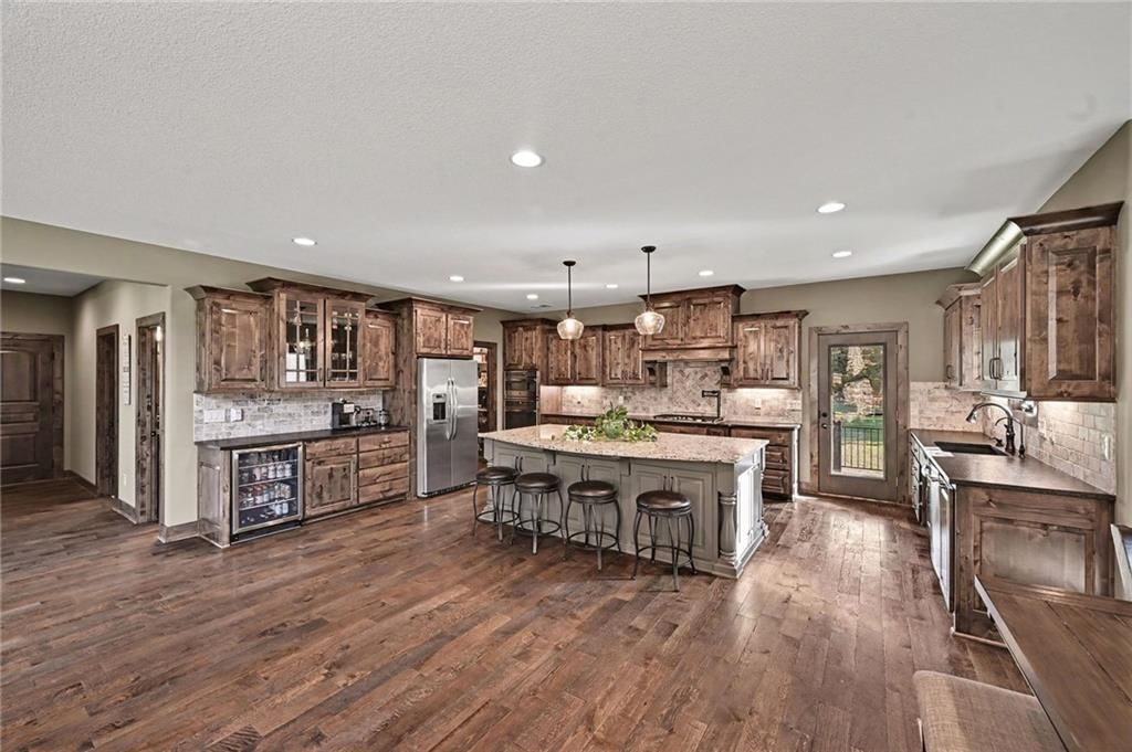 Kitchen island, double oven and kitchen backsplash at 12924 Jacob Lane, Kearney, MO 64060