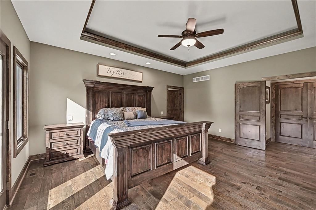 Main-floor primary bedroom and tray ceiling at 12924 Jacob Lane, Kearney, MO 64060