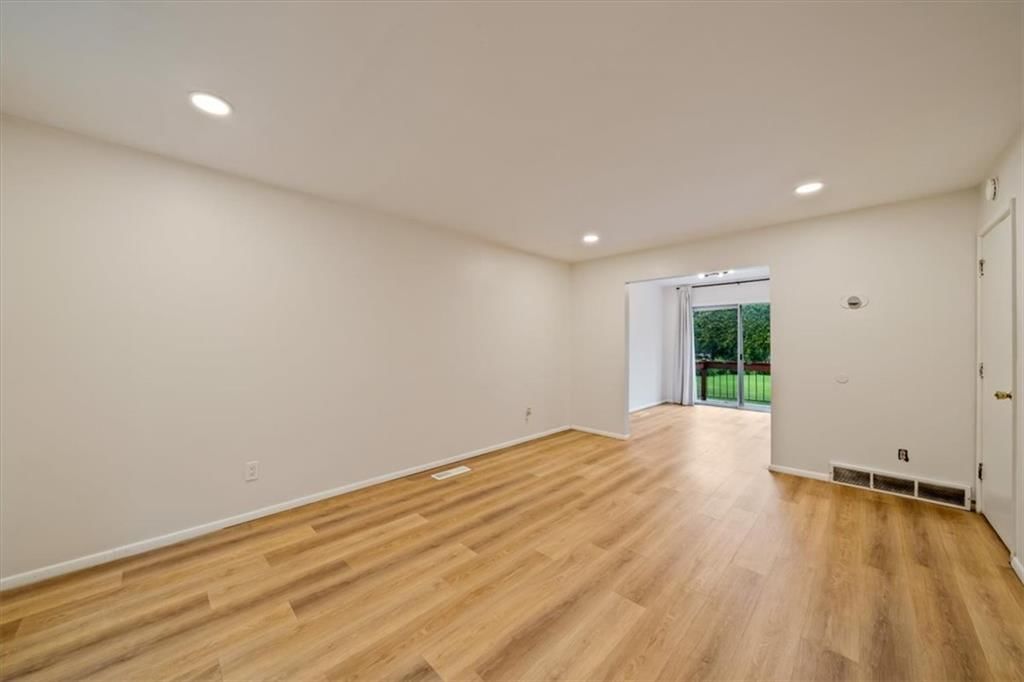 Recessed lighting, white trim and white walls at 8727 Sycamore Avenue, Kansas City, MO 64138