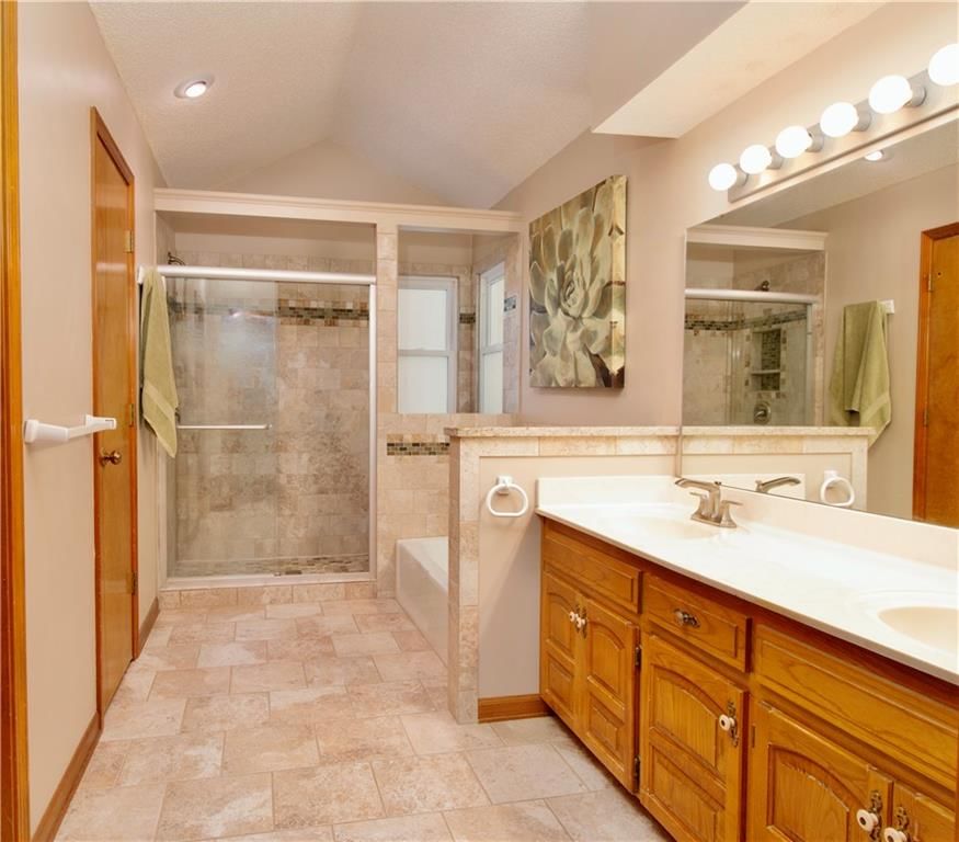 Walk-in shower, tiled shower and double vanity at 15800 W 125th Terrace, Olathe, KS 66062