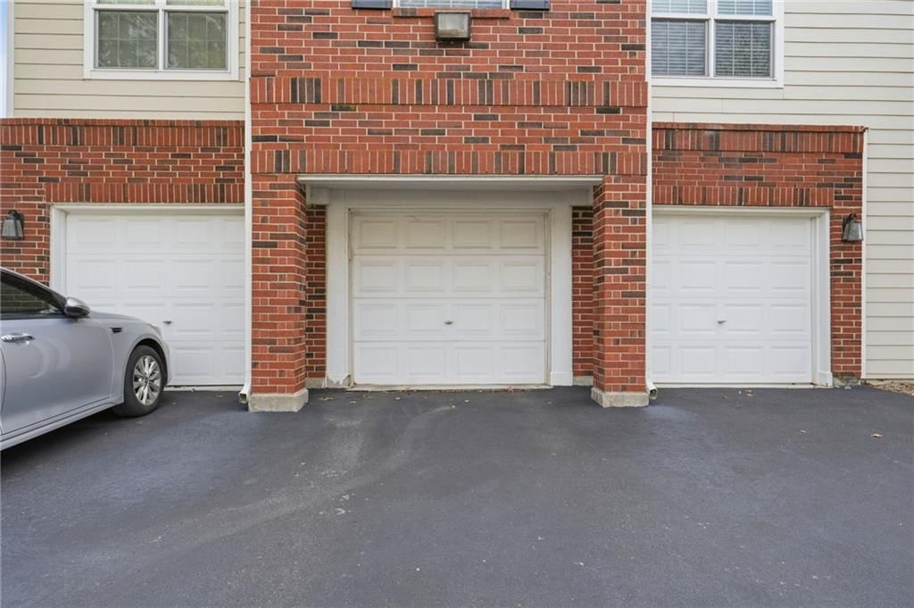 Attached garage and concrete driveway at 11604 Tomahawk Creek Parkway #A, Leawood, KS 66211