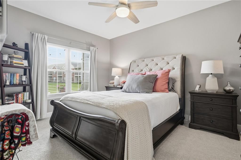 Main-floor primary bedroom and carpet at 11604 Tomahawk Creek Parkway #A, Leawood, KS 66211