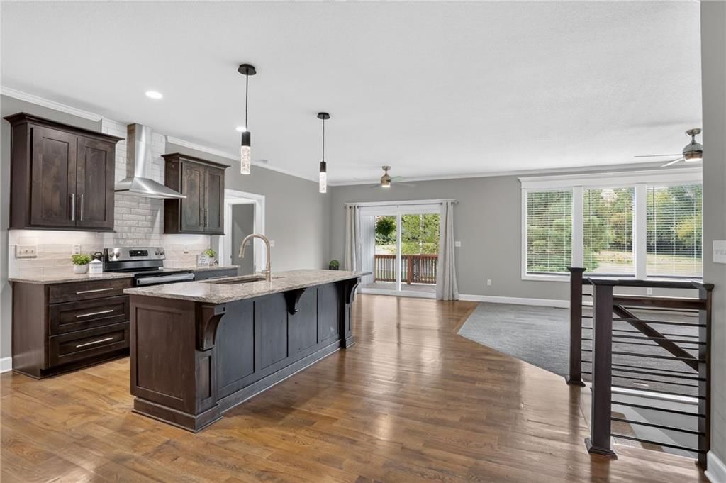Open floor plan, kitchen island and hardwood floors at 21421 E 32nd Terrace S, Independence, MO 64057