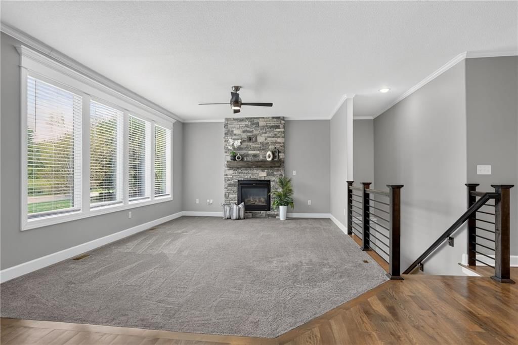 Fireplace, staircase and iron stair railing at 21421 E 32nd Terrace S, Independence, MO 64057
