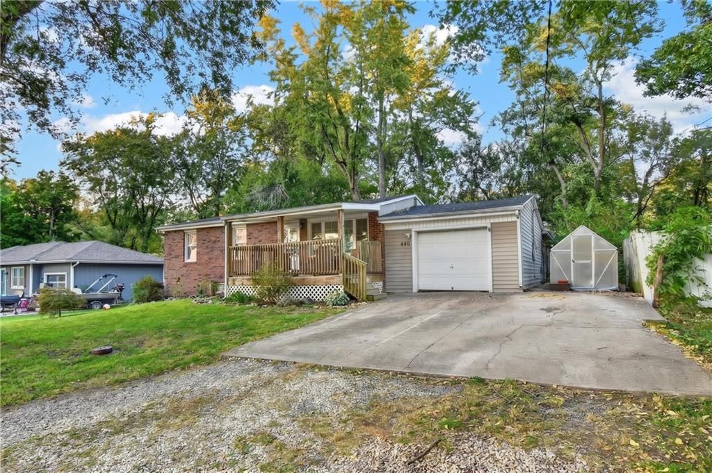 Attached garage and concrete driveway at 440 W Broadway Street, Peculiar, MO 64078