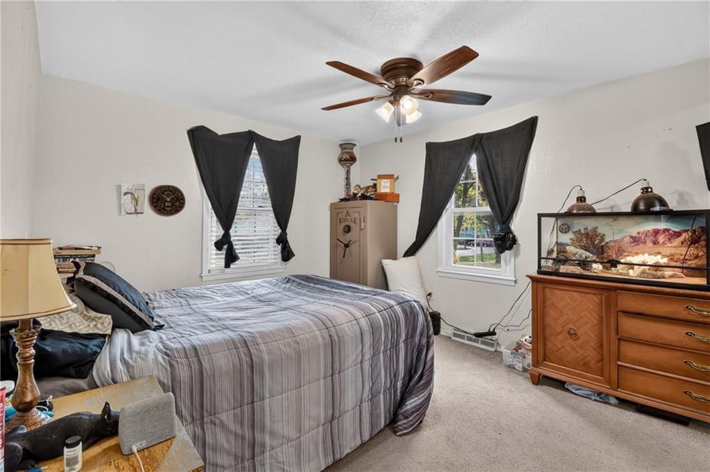 Main-floor primary bedroom and carpet at 440 W Broadway Street, Peculiar, MO 64078