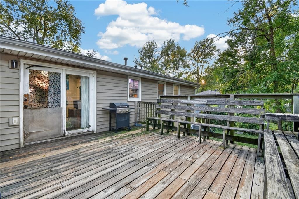 Big backyard, fenced yard and mature trees at 440 W Broadway Street, Peculiar, MO 64078