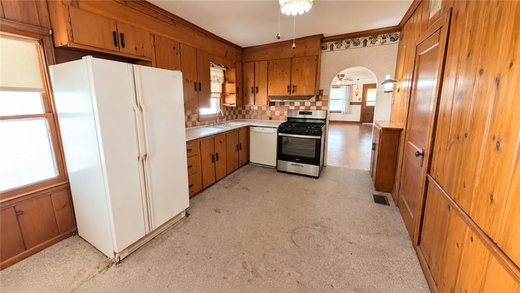 Kitchen open to the living area and kitchen backsplash at 1820 S 22nd Street, Kansas City, KS 66106
