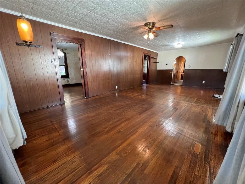 Main-floor primary bedroom, hardwood floors and shiplap / paneling at 1820 S 22nd Street, Kansas City, KS 66106