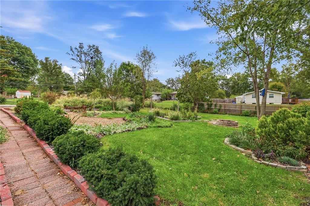 Big backyard, mature trees and flat lot at 5901 N Michigan Place, Gladstone, MO 64118