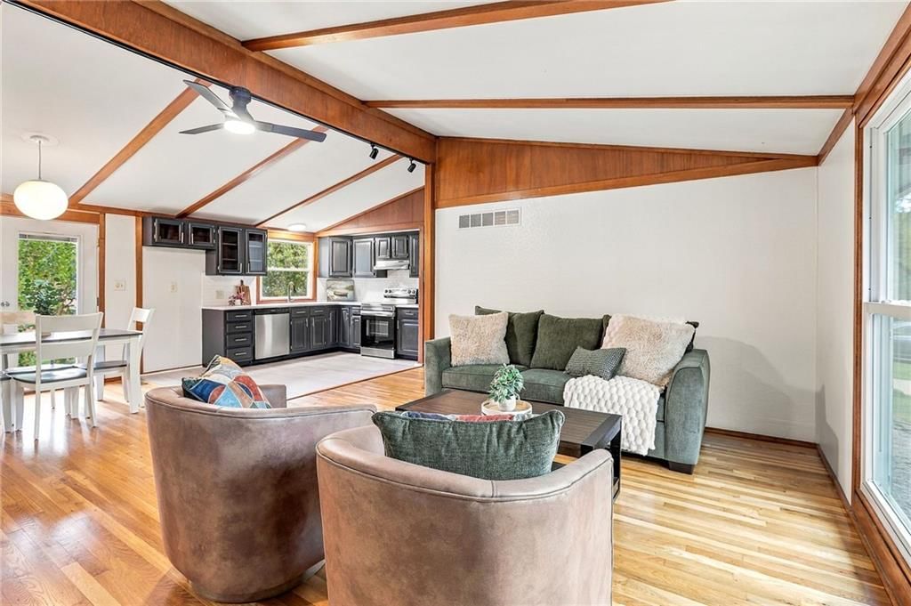 Open floor plan, ceiling beams and white walls at 5901 N Michigan Place, Gladstone, MO 64118