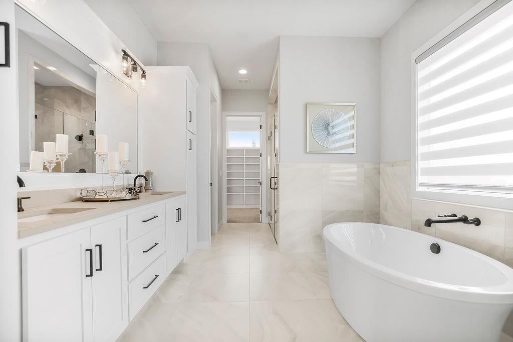Private toilet room, double vanity and white vanity at 7936 Noble Street, Shawnee, KS 66220