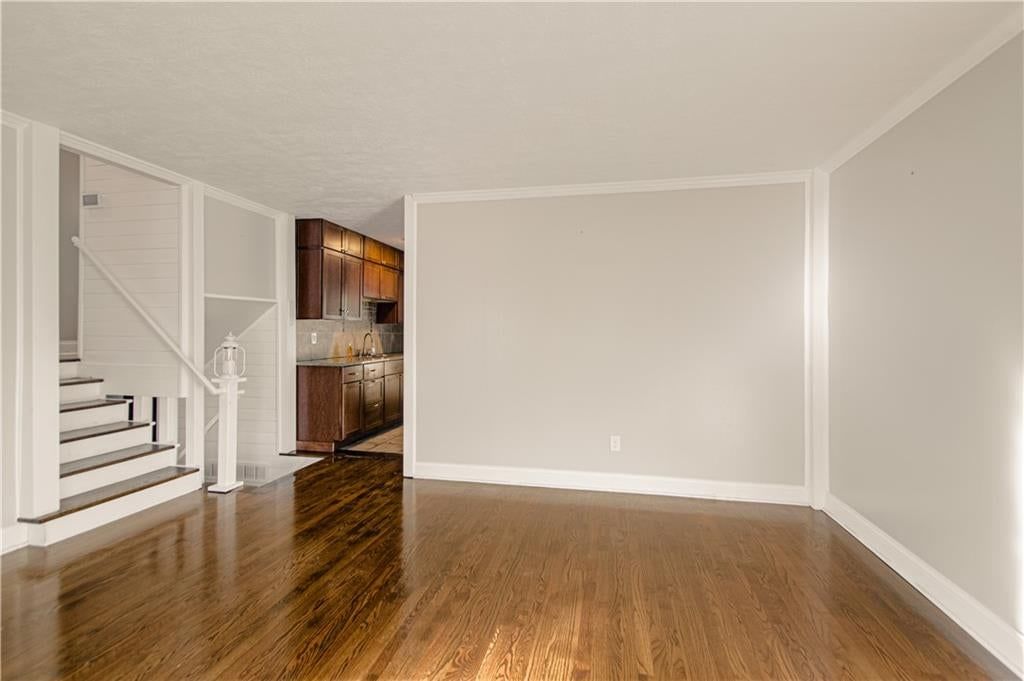 Hardwood floors, shiplap / paneling and staircase at 10006 Benson Street, Overland Park, KS 66212