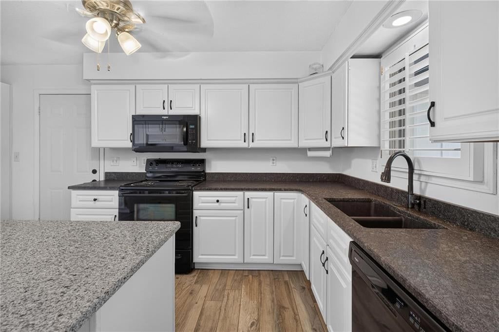 Kitchen island and white kitchen at 19475 Hardy Street, Overland Park, KS 66085