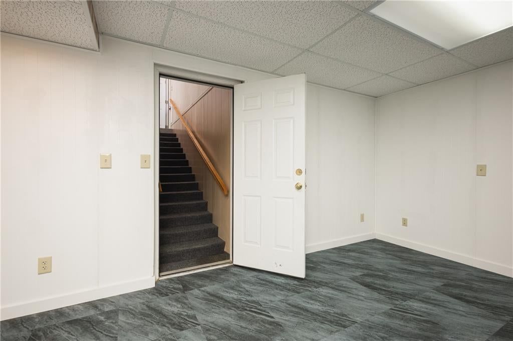 Finished basement, staircase and wood stair railing at 116 Sibley Street, Buckner, MO 64016