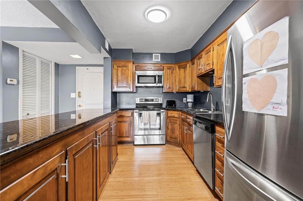 Granite counters, stainless steel appliances and wood kitchen cabinets at 4545 Wornall Road #1109, Kansas City, MO 64111