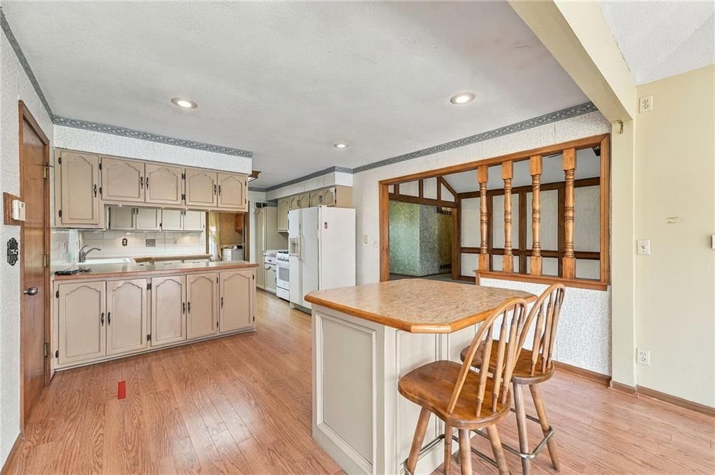 Open floor plan, kitchen island and recessed lighting at 5905 E 210th Street, Belton, MO 64012