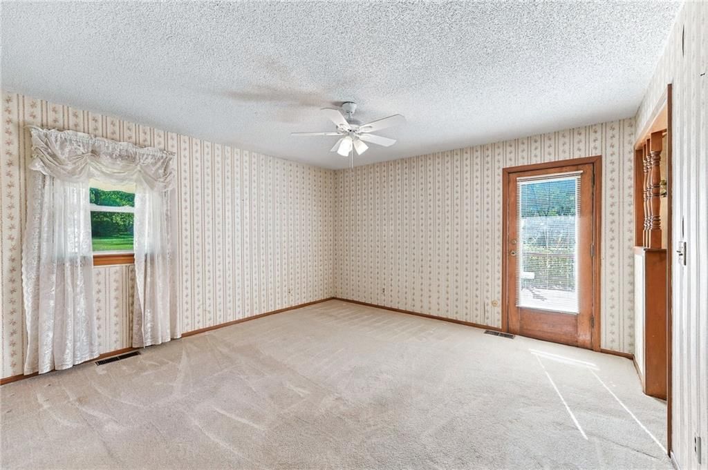 Main-floor primary bedroom and carpet at 5905 E 210th Street, Belton, MO 64012