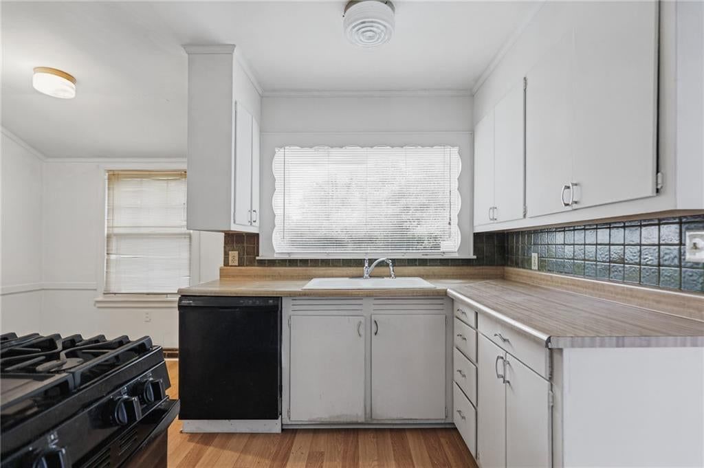 White kitchen, gas range and kitchen backsplash at 8932 E 66th Street, Raytown, MO 64133