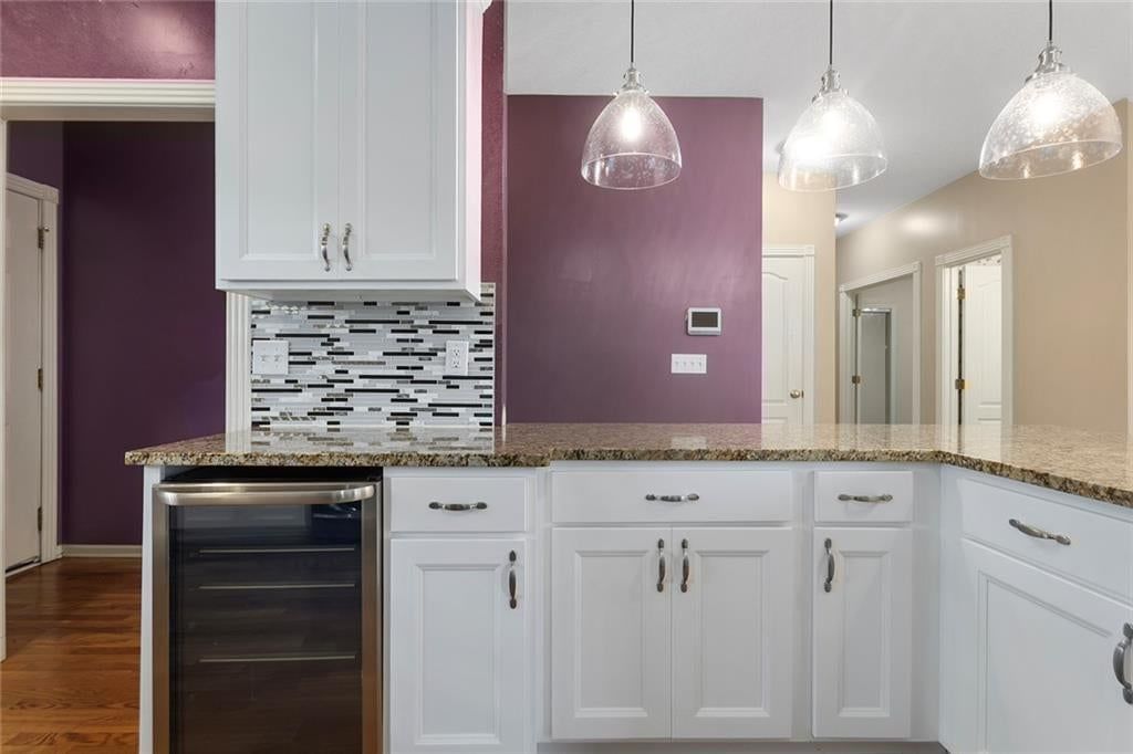 Kitchen island and statement lighting at 12133 S Valley Road, Olathe, KS 66061