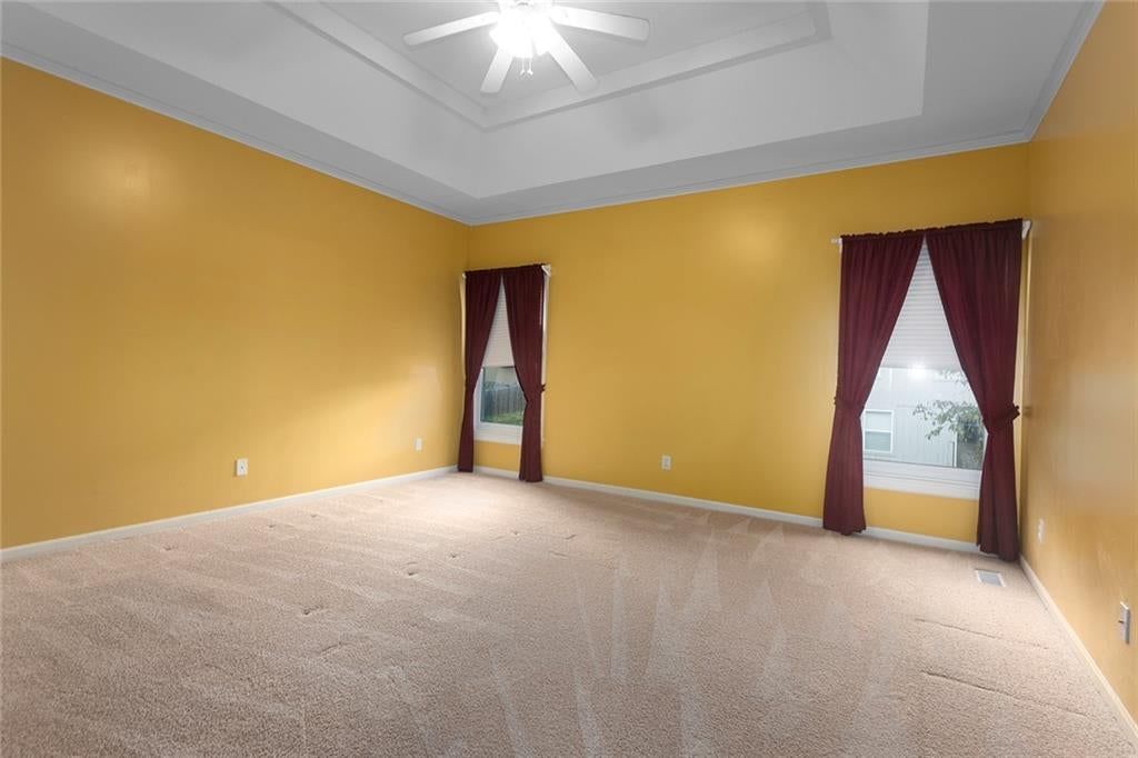 Main-floor primary bedroom and carpet at 12133 S Valley Road, Olathe, KS 66061