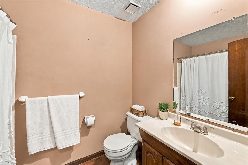 Double vanity, wood vanity and tub and shower combo at 1926 4th Street, Lee's Summit, MO 64081