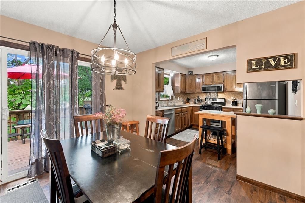 Open floor plan, statement lighting and wall of windows at 1926 4th Street, Lee's Summit, MO 64081