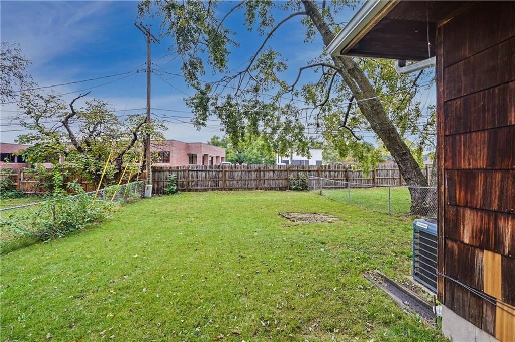 Fenced yard and mature trees at 9734 Hadley Drive, Overland Park, KS 66212