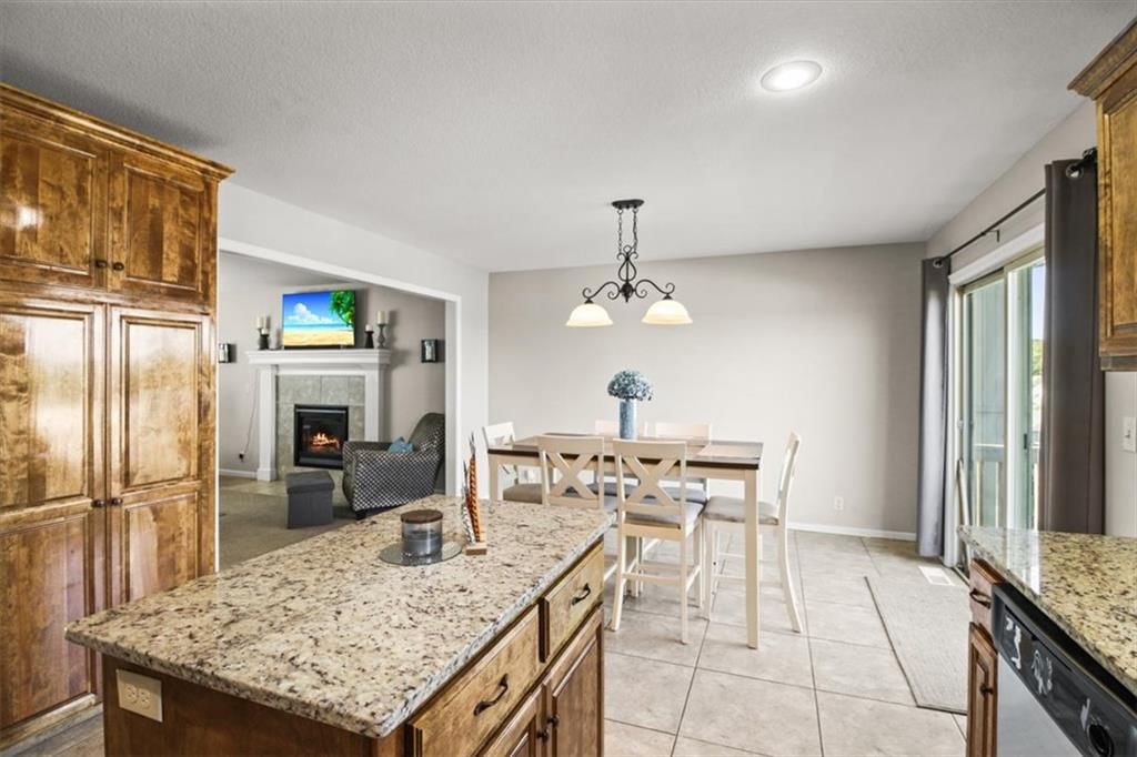 Kitchen island, granite counters and stainless steel appliances at 1252 NW High View Drive, Grain Valley, MO 64029