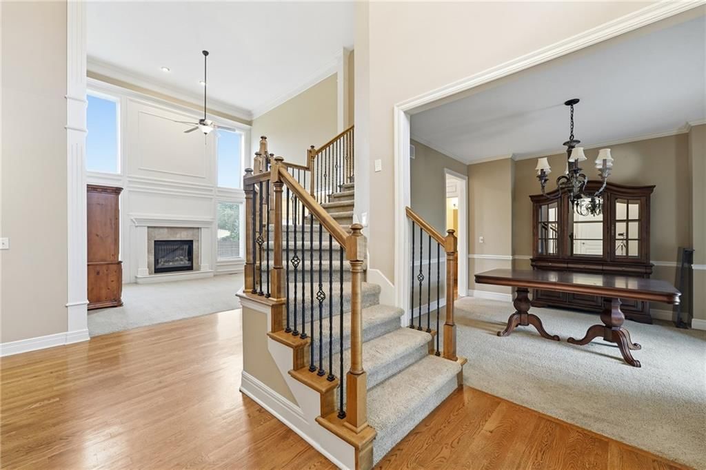 Hardwood floors, staircase and iron stair railing at 10303 N Dallas Avenue, Kansas City, MO 64154