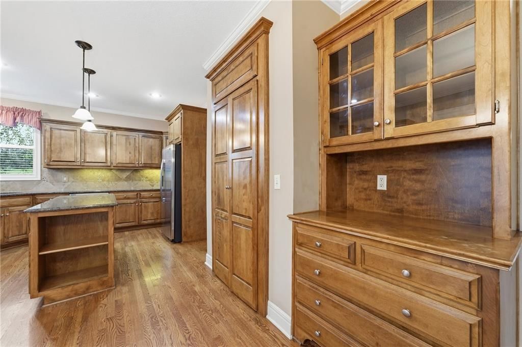 Kitchen backsplash and mixed-finish hardware at 10303 N Dallas Avenue, Kansas City, MO 64154