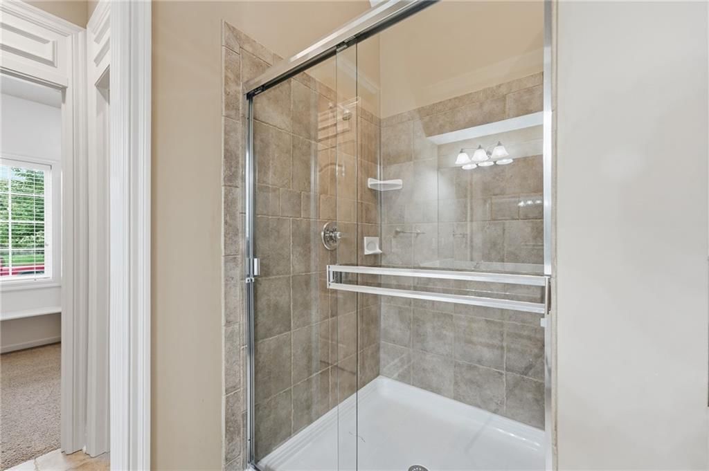 Walk-in shower and tiled shower at 10303 N Dallas Avenue, Kansas City, MO 64154