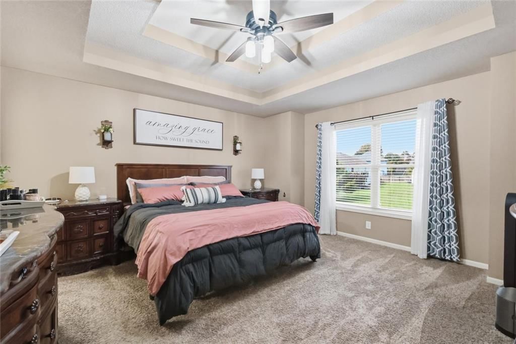 Main-floor primary bedroom and tray ceiling at 11226 N Belleview Avenue, Kansas City, MO 64155