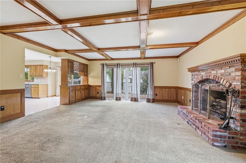 Fireplace, open floor plan and coffered ceiling at 14933 W 82nd Terrace, Lenexa, KS 66215