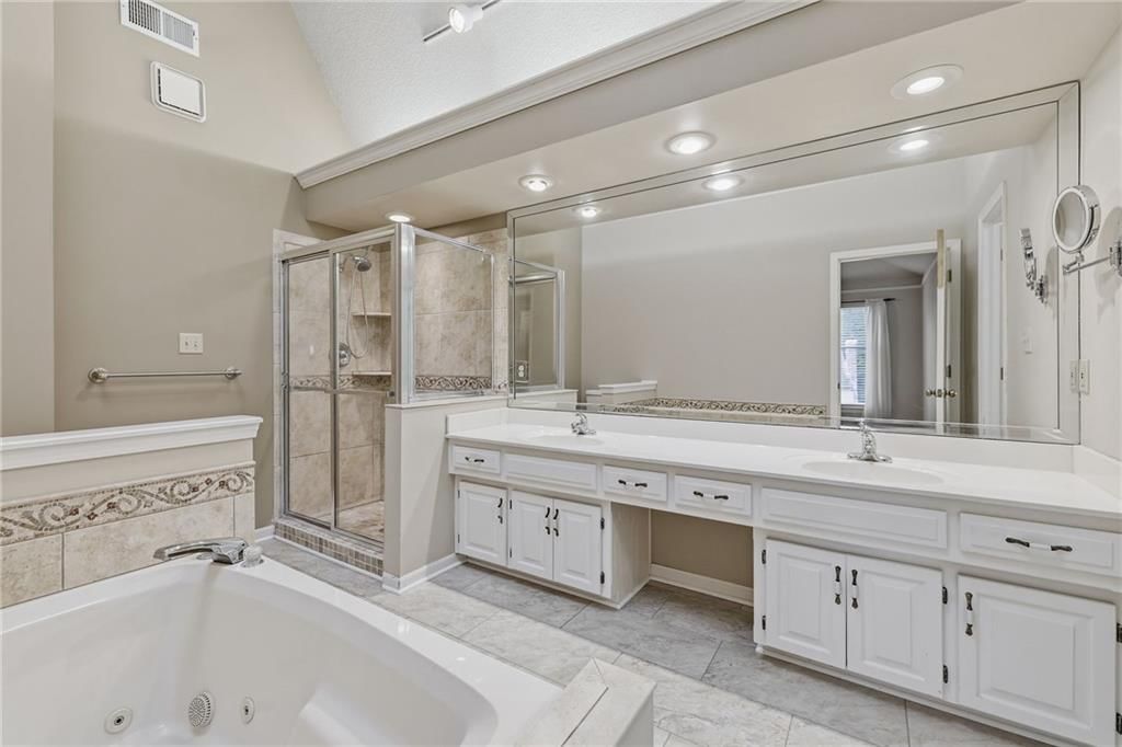 Walk-in shower, tiled shower and double vanity at 14933 W 82nd Terrace, Lenexa, KS 66215