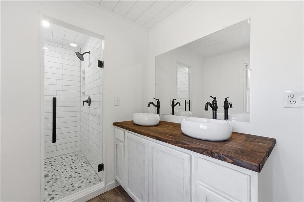 Walk-in shower, tiled shower and double vanity at 1305 Madison Street, Lee's Summit, MO 64081
