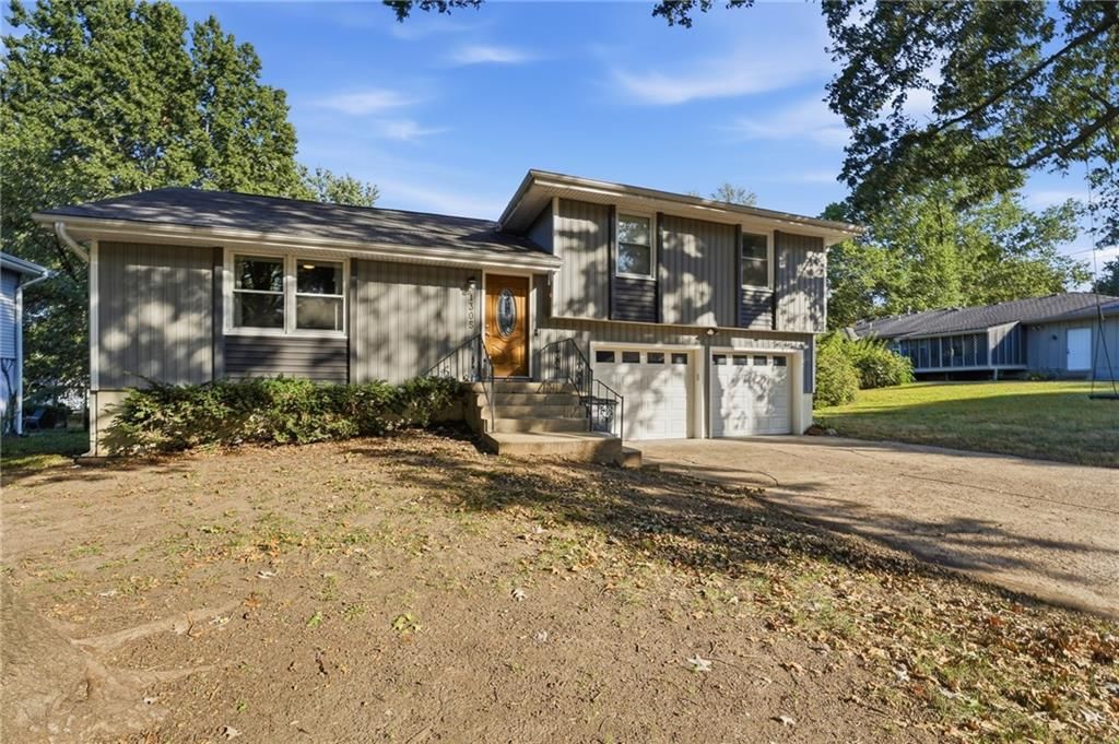 Deck, big backyard and fenced yard at 1305 Madison Street, Lee's Summit, MO 64081